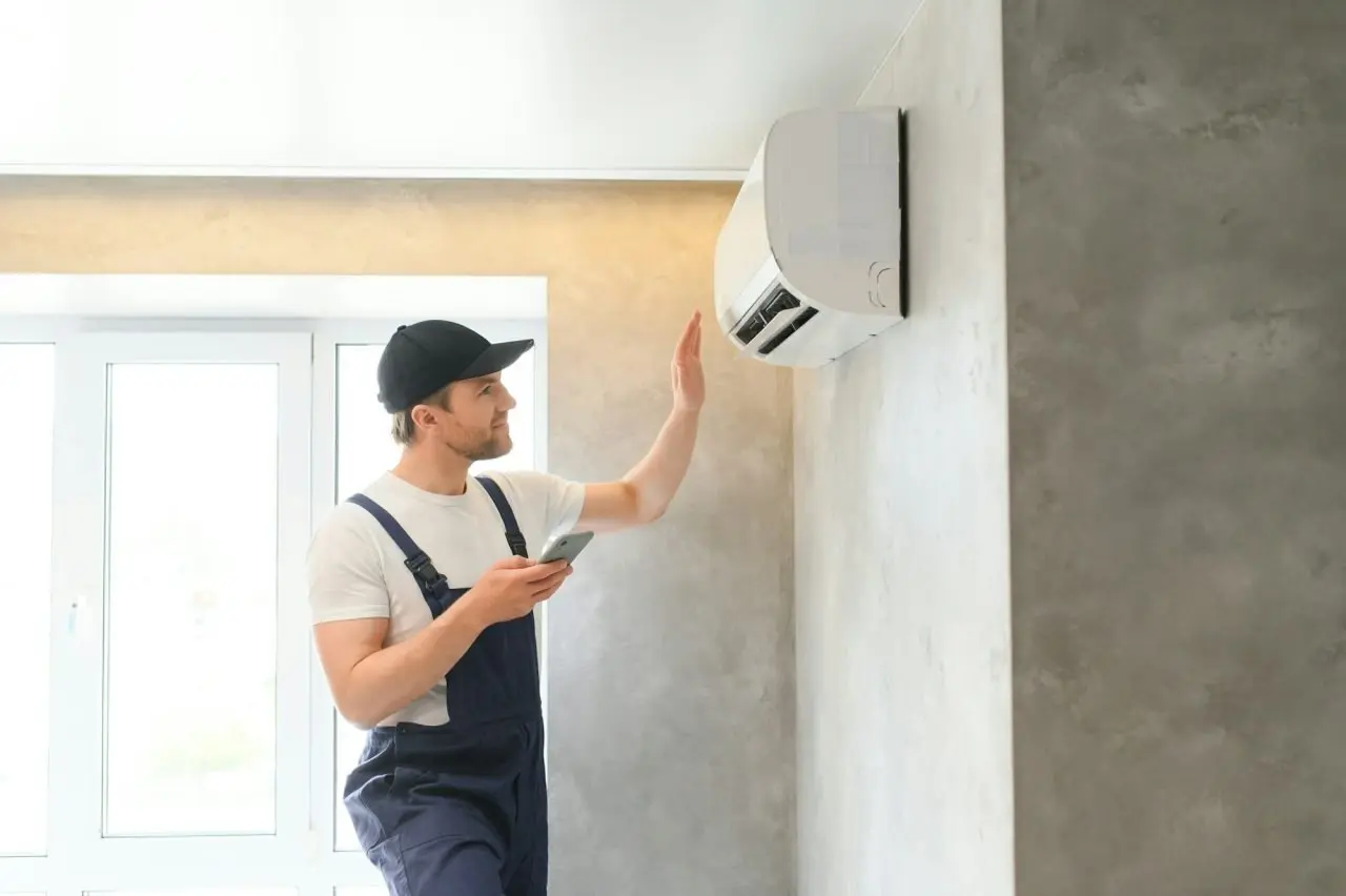 service man is cleaning repair and maintenance of air conditioner 1 2